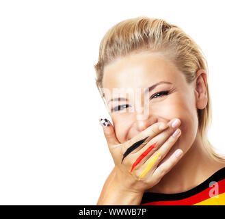 Smiling football fan, closeup on face, female covering mouth with painted in flag colors hand, woman expressing emotions of joy, German team supporter Stock Photo