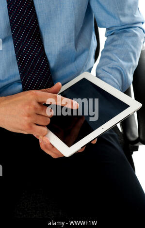 Closeup shot of businessman operating tablet pc using his fingers. Touch screen technology Stock Photo