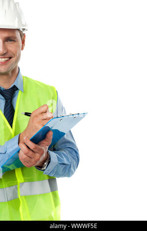 Cropped image of an architect engineer with clipboard and pen wearing helmet Stock Photo