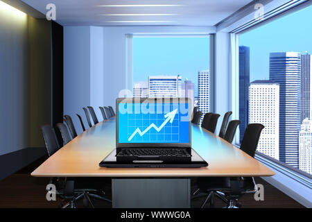 meeting room, in front focus placed on graph shiwing progress on laptop screen Stock Photo