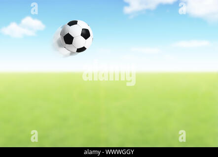 Football ball flying over field Stock Photo