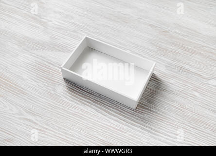 Blank opened box on light wood table background. Responsive design template. Stock Photo