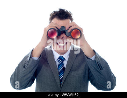 Smiling businessman looks through binoculars and seeks success. All on white background Stock Photo