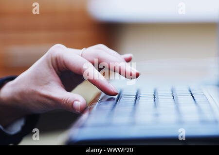 human hand going to press key on keyboard Stock Photo