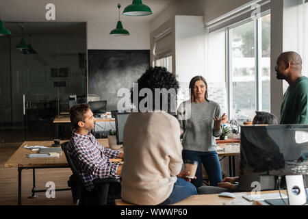 Diverse designers discussing a project together in their office Stock Photo