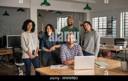 Diverse team of smiling designers working together in an office Stock Photo