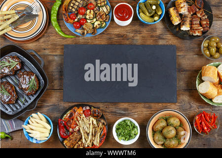 Dinner table. Various snacks of grill and barbecue on a wooden table. country style Stock Photo