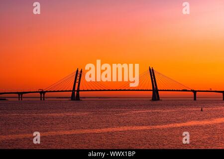 Landscape with new cable stayed bridge on orange sunset backdrop.. Western high-speed diameter, Bolshoy Obuhovskiy Bridge in Saint Petersburg. New lan Stock Photo