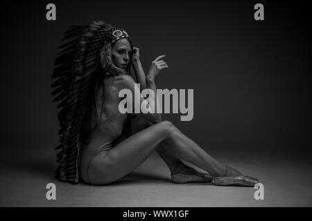 Spirituality, beautiful american indian woman with big plume of brown feathers. dancing like the spirit of freedom Stock Photo