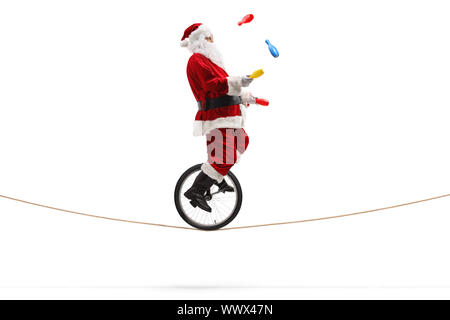 Elderly man a riding a unicycle and juggling isolated on white ...