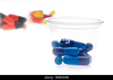 Colorful tablets, capsules in a cup Stock Photo