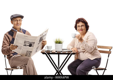 Senior man and woman having coffee and reading newspaper isolated on white background Stock Photo