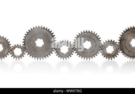 Old metallic cog gears arranged in a row. Stock Photo