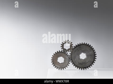 Still life with three old cog gears. Lots of copy space. Stock Photo