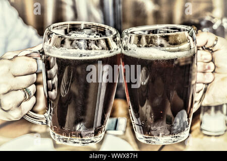 Drinking beer in the pub. glasses of beer in hands Stock Photo