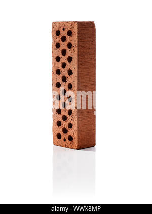 Perforated brick on white reflecting background Stock Photo