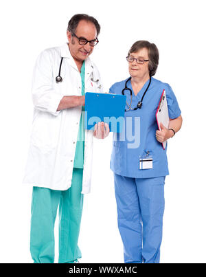 Doctors discussing a medical report isolated over white Stock Photo