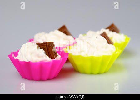 Four portions of whipped cream over white background. Stock Photo