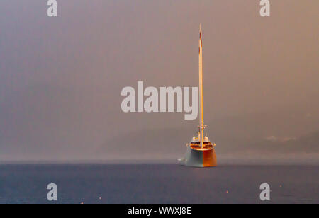 Sailing Yacht A emerges from an early morning storm Stock Photo