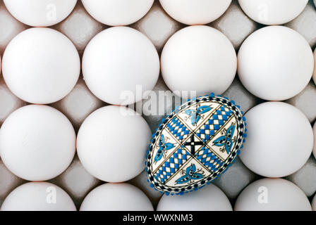 handmade romanian decorated easter egg on white eggs cardboard Stock Photo