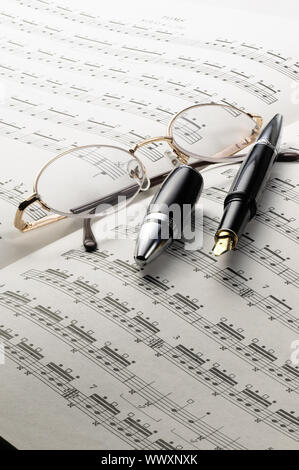 music charts with glasses and pen on top Stock Photo