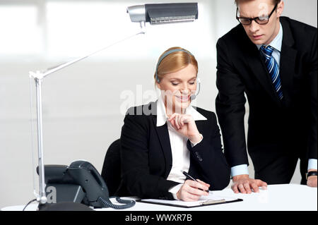 Young business people reading documents in the office and making corrections Stock Photo