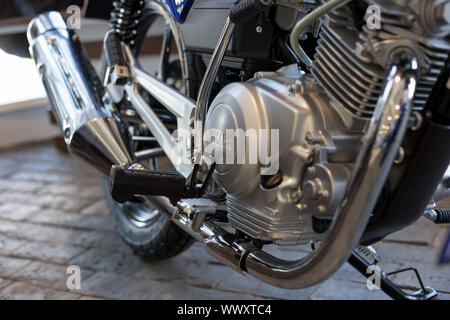 Russia, Izhevsk - August 23, 2019: Yamaha motorcycle shop. Cropped image of new motorbike YBR125. Famous world brand. Stock Photo