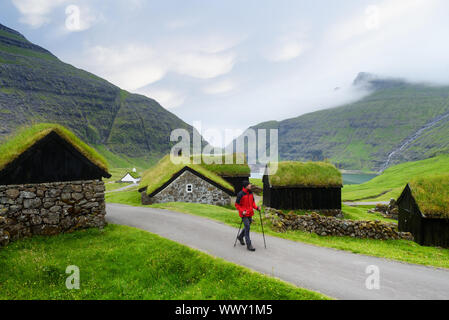 Saksun Village, Streymoy Island, Faroe islands. Old stone houses with a grass (turf) roof. Tourist sightseeing in green valley Stock Photo