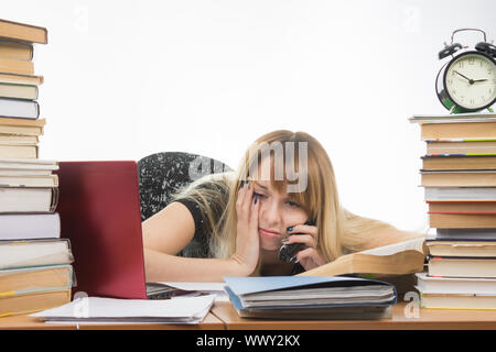 Tired student late at night talking on the phone Stock Photo