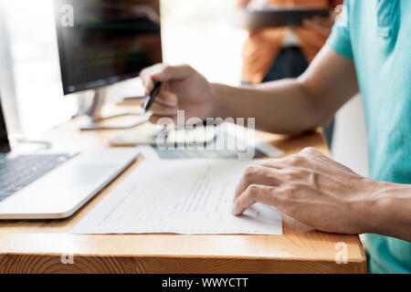 Pensive programmer working on on desktop pc programming code technologies or website design at office Software Development Company. Stock Photo