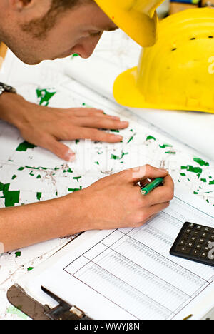 construction worker checking calculating and documents, maps and charts Stock Photo