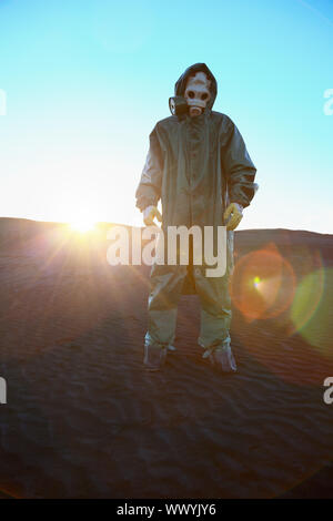 A man in protective suit and bright rays of the sun