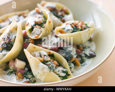 Conchiglioni pasta shells with Spinach Pancetta Pine Nuts and Go Stock Photo