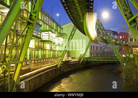 moving Wuppertal cable railway over the river Wupper in the evening, Wuppertal, Germany, Europe Stock Photo