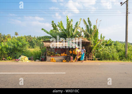 Street sale at the road to Tangalle. Woman in front of her market stall Stock Photo