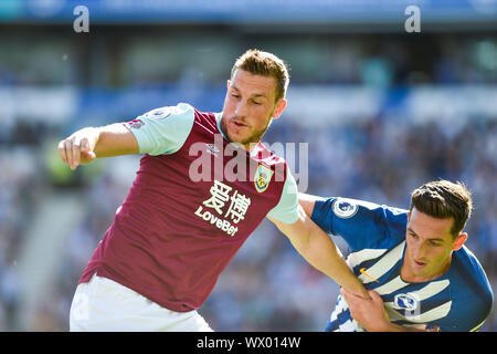 Chris Wood of Burnley holds off Lewis Dunk of Brighton during the Premier League match between Brighton and Hove Albion and Burnley at the American Express Community Stadium , Brighton , 14 September 2019 Photo Simon Dack/Telephoto Images.  Editorial use only. No merchandising. For Football images FA and Premier League restrictions apply inc. no internet/mobile usage without FAPL license - for details contact Football Dataco