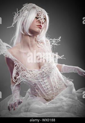 Entertainment violinist, woman with string musical instrument in a white gothic style Stock Photo