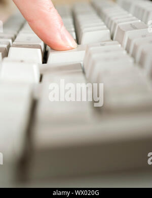 Fingers type a text on the computer keyboard Stock Photo