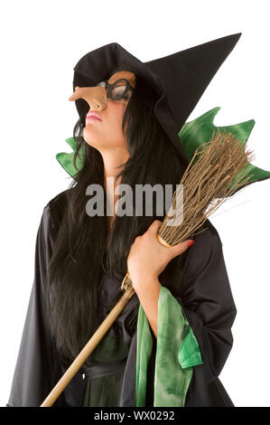 profile of old ugly witch with big nose and glasses arming a broom Stock Photo