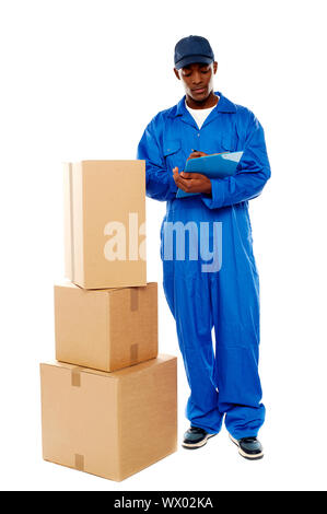 Delivery boy at work. Kindly accept your goods. All on white background Stock Photo
