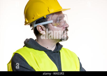 Do it yourself, man dressed in yellow builder helmet with protective glasses ready to start the construction work Stock Photo