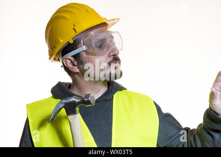 Do it yourself, man dressed in yellow builder helmet with protective glasses ready to start the construction work Stock Photo