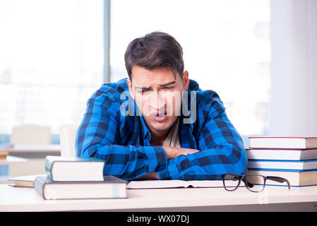 Student studying in the empty library with book preparing for ex Stock Photo
