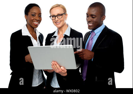 Team of friendly business people using laptop isolated on white Stock Photo