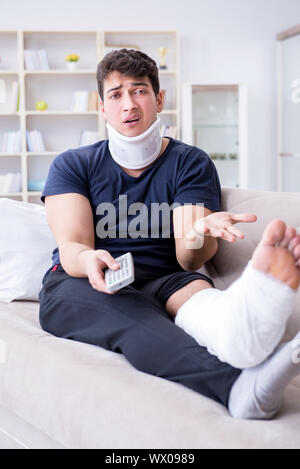 Man injured in car crash recovering at home from whiplash injury Stock Photo