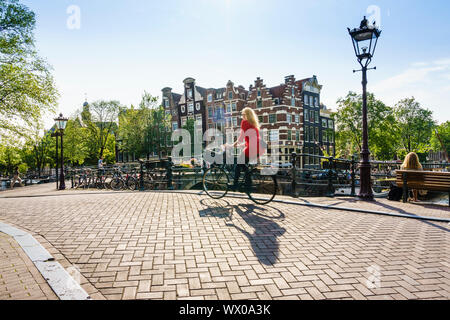 Cyclists on a bridge over Brouwersgracht, Amsterdam, North Holland, The Netherlands, Europe Stock Photo