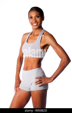 Beautiful toned muscular fitness body of happy smiling African female  athlete in grey, isolated Stock Photo - Alamy