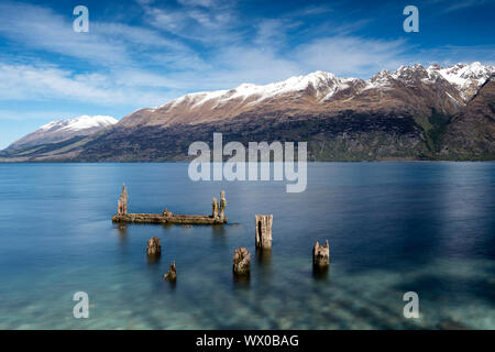 Decayed jetty, old wooden posts in Lake Wakatipu at Glenorchy, Otago Region, South Island, New Zealand, Pacific Stock Photo