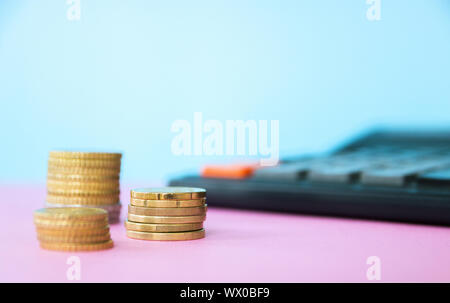 the future of Finance, business banking and financial concept. Flatlay cents, calculator on a pink background. Stock Photo