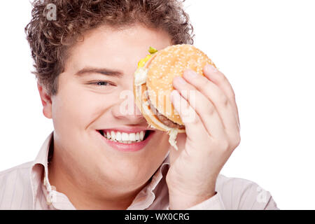 Young chubby man holding  hamburger, isolated on white Stock Photo